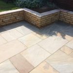 The sandstone retaining wall and sandstone patio area.