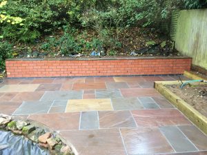 Another view of the completed retaining wall and Indian Sandstone patio built in Wilbarston, near Market Harborough.