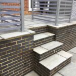 The retaining wall and steps to the new raised patio area