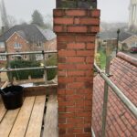 TDJ Construction erect scaffolding to begin removing the chimney